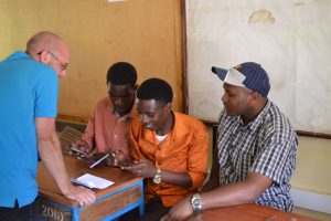 Rotarian James Mepham showing IT staff at another government school how to access Teacher in a Box from their phones