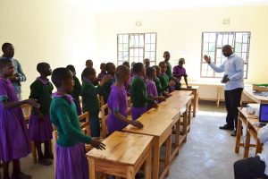 East Meru Community School students with teacher, Absalom Shanguya.